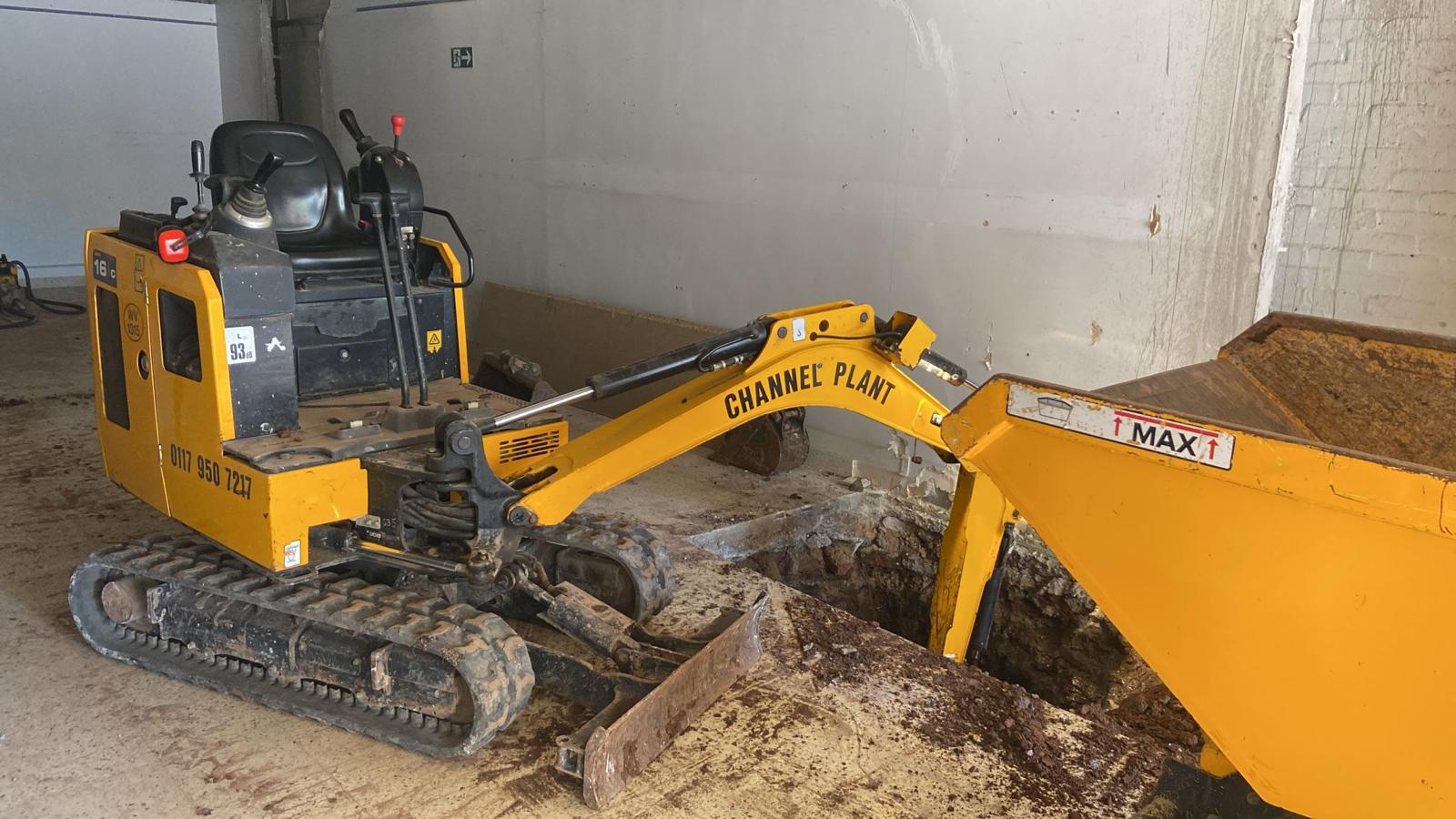 Micro digger working in a restricted-access area
